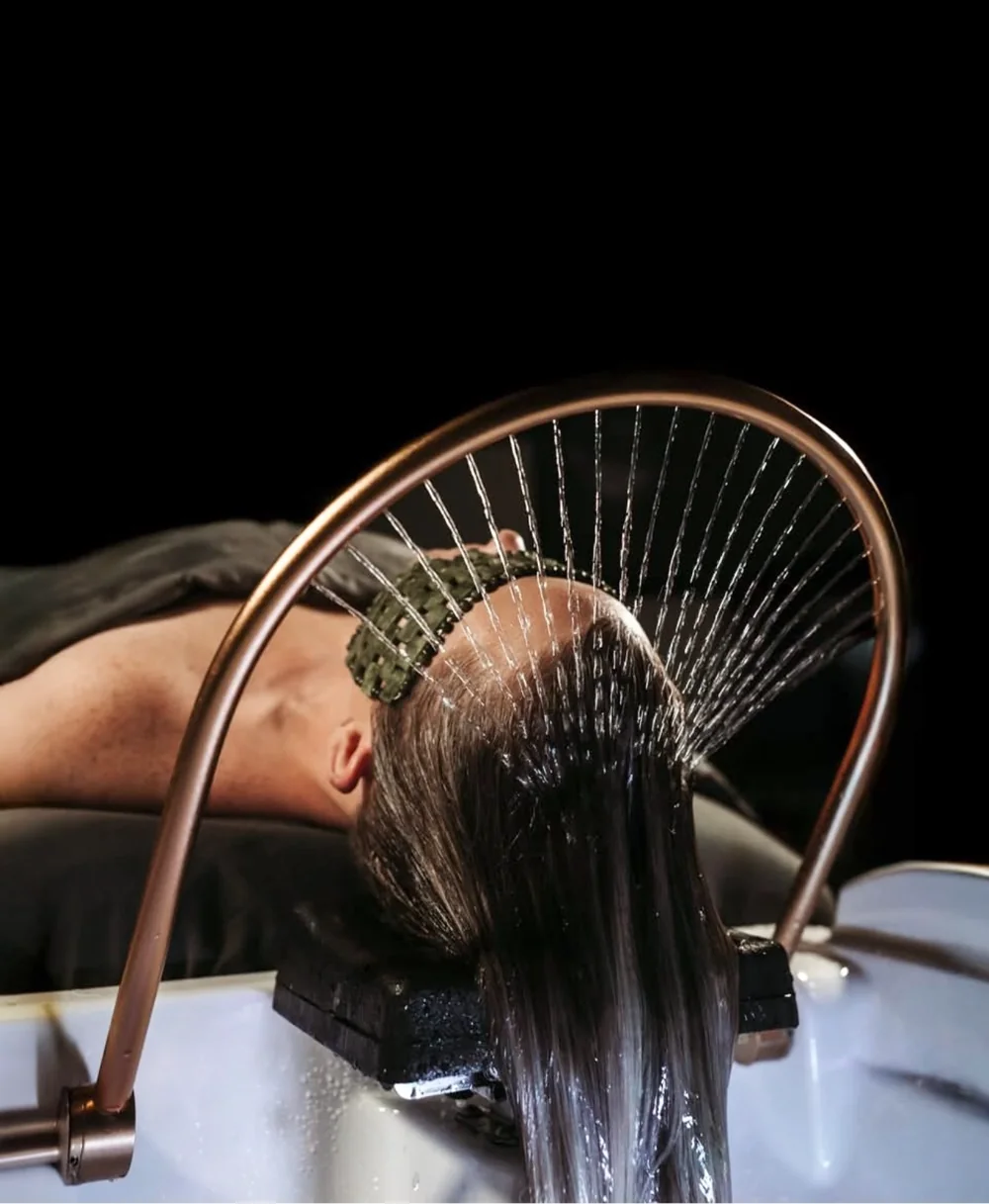 The waterfall rinse over the Japanese shampoo bed during a Runway head spa